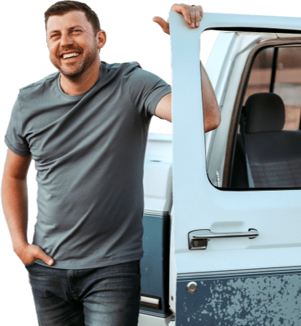 Levi Riggs stands next to the open door of a pickup truck